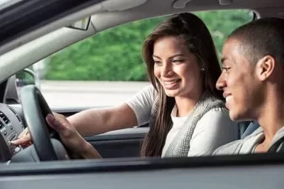 Female driving instructor giving in vehicle driving lesson on defensive driving education course for driver training brampton